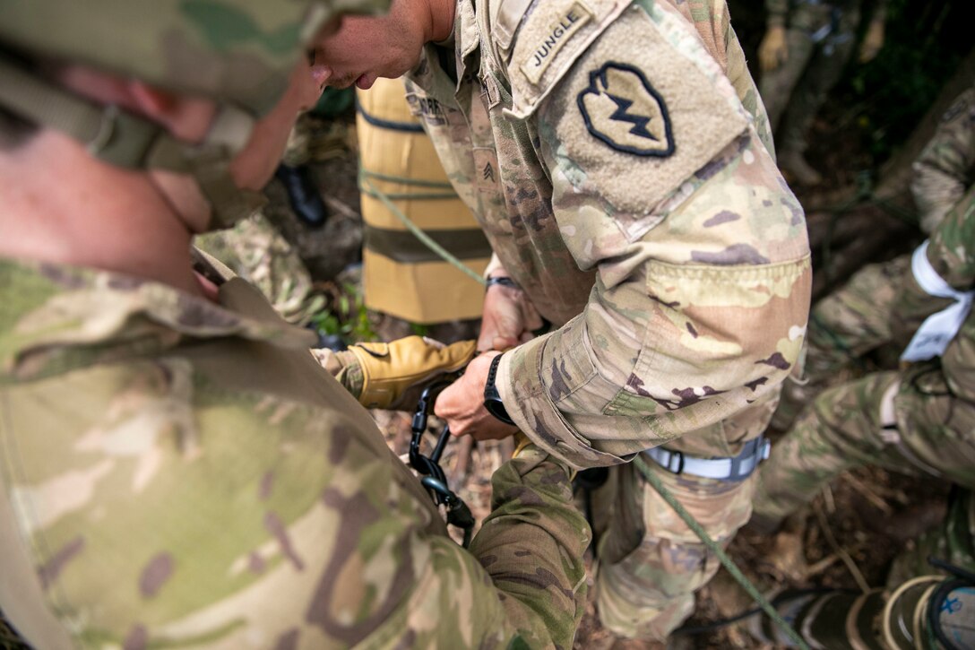 U.S. Army Sgt. Jacob Morriss, a squad leader, Bravo Company, 2nd Battalion, 27th Infantry Regiment, 3rd Infantry Brigade Combat Team, 25th Infantry Division, hooks in a Soldier from the New Zealand Army during rappel instruction at Exercise Cartwheel, Nadi, Fiji, September 18, 2022. Exercise Cartwheel is a multilateral military-to-military training exercise with the United States, Republic of Fiji Military, Australian, New Zealand, and British forces that builds expeditionary readiness and interoperability by increasing the capacity to face a crisis and contingencies by developing and stressing units at the highest training levels.