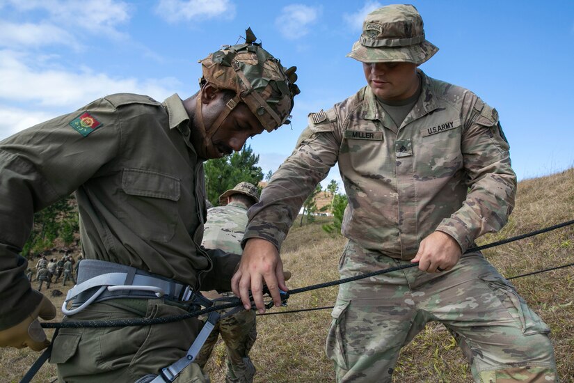 U.S. Army Sgt. Jacob Miller, an infantryman with Bravo Company, 2nd Battalion, 27th Infantry Regiment, 3rd Infantry Brigade Combat Team, 25th Infantry Division, shows a Soldier with the Republic of Fiji Military Force how to tie in during rappel instruction in the highlands during Exercise Cartwheel, Nadi, Fiji, September 18, 2022. Bilateral military-to-military training with the RFMF builds expeditionary readiness and interoperability by increasing the capacity to face crises and contingencies by developing and stressing units at the highest training levels.