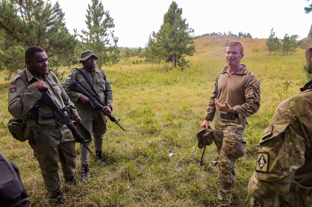 Spc. Connor MacDowell, a team leader assigned to B Company, 2nd Battalion, 27th Infantry Regiment, 3rd Infantry Brigade Combat Team, 25th Infantry Division discusses small unit movement techniques with New Zealand and Fijian soldiers during a break-contact drill as part of Exercise Cartwheel at Nausori Highlands Training Area, Fiji, September 17, 2022. Exercise Cartwheel is a multilateral military-to-military training exercise with the U.S., Republic of Fiji Military, Australian, New Zealand, and British forces that builds expeditionary readiness and interoperability by increasing the capacity to face a crisis and contingencies by developing and stressing units at the highest training levels.