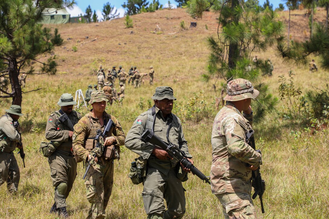 A U.S. Soldier assigned to B Company, 2nd Battalion, 27th Infantry Regiment, 3rd Infantry Brigade Combat Team, 25th Infantry Division, a New Zealand soldier assigned to 2nd/1st Royal New Zealand Infantry Regiment, and Fijian Soldiers assigned to 3rd Battalion Fiji Infantry Regiment begin a tactical movement drill as part of Exercise Cartwheel at Nausori Highlands Training Area, Fiji, September 17, 2022. Exercise Cartwheel is a multilateral military-to-military training exercise with the U.S., Republic of Fiji Military, Australian, New Zealand, and British forces that builds expeditionary readiness and interoperability by increasing the capacity to face a crisis and contingencies by developing and stressing units at the highest training levels.