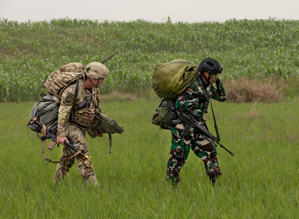 A U.S. Army and Tentara Nasional Indonesia paratroopers march alongside one another during joint airborne operations in support of Super Garuda Airborne on Aug. 3, 2022 in Baturaja, Indonesia. Super Garuda Shield, a part of Operation Pathways and a longstanding annual, bilateral military exercise conducted between the U.S. military and Indonesia National Armed Forces, reinforces the U.S. commitments to our allies, and regional partners, joint readiness, and the interoperability to fight and win together. (U.S. Army photo by Sgt. Nicholle Salvatierra, 201st TPASE)