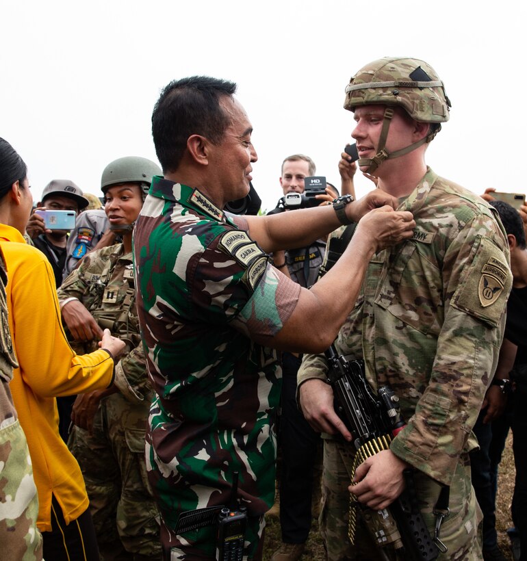 Gen. Andika Perkasa, commander of the Tentara Nasional Indonesia, pins jump wings onto a U.S. Army paratrooper during a wing ceremony in Baturaja, Indonesia, Aug. 3, 2022. Super Garuda Shield, a part of Operation Pathways and a longstanding annual, bilateral military exercise conducted between the U.S. military and Indonesia National Armed Forces, reinforces the U.S. commitments to our allies, and regional partners, joint readiness, and the interoperability to fight and win together. (U.S. Army photo by Sgt. Nicholle Salvatierra, 201st TPASE)