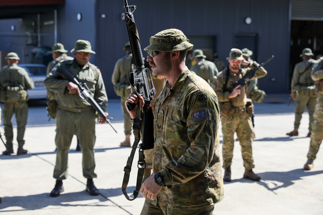 Australian Cpl. Louis Carbery, an infantry soldier of the 8/9th battalion Royal Australian regiment, shows how his army clears hallways and intersections in a shoot house, in Fiji, on September 13, 2022. Exercise Cartwheel is a multilateral military-to-military training exercise with the United States, Republic of Fiji Military, Australian, New Zealand, and British forces that builds expeditionary readiness and interoperability by increasing the capacity to face a crisis and contingencies by developing and stressing units at the highest training levels.