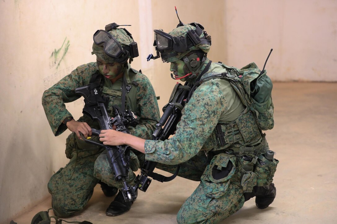 SINGAPORE - Singapore Armed Forces (SAF) soldiers participate in a Field Training Exercise (FTX) during Exercise Tiger Balm 2022 here, June 15, 2022. The annual Tiger Balm Exercise has several events to showcase the differences between the forces, but also to expand the knowledge of each other's tactical strategies and increase interoperability. (U.S. Army Reserve photo by Spc. Midori Preecs/Released)