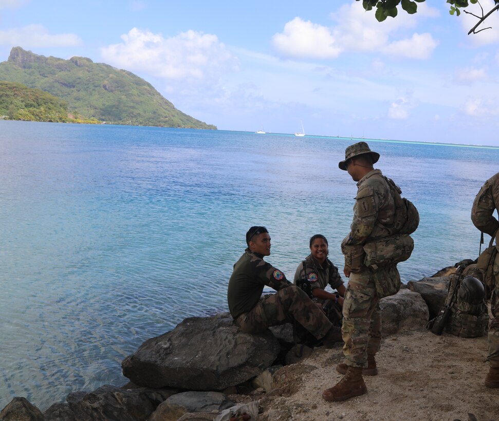 U.S. and French soldiers take a break after establishing tactical control points in Huahine, French Polynesia during Marara 22. Marara 22 reinforces multinational partnerships by building readiness and interoperability for future contingencies throughout the Indo-Pacific. Through training, skill-sharing, and cultural exchanges, partnerships and allies share common interests in ensuring a free and open Indo-Pacific through bilateral military-military engagements. (U.S. Army photo by Master Sgt. Shelia L. Cooper, 8th Theater Sustainment Command)