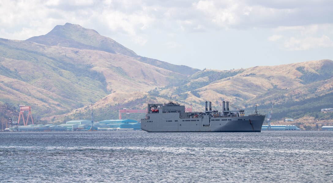 The U.S. Naval Ship Red Cloud sits anchored in Subic Bay, Philippines after the successful download of Army Prepositioned Stock-3, also known as APS Afloat. Units from the U.S. Army Sustainment Command executed a vessel download of APS Afloat in order to employ and maintain the APS equipment set forward in the Indo-Pacific Theater. (U.S. Army photo by Katie Nelson, 402nd Army Field Support Brigade)