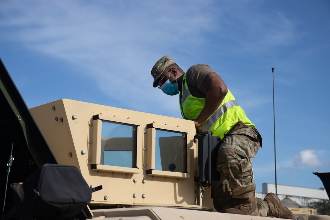 Army Field Support Battalion-Charleston's Sgt. 1st Class Jean Monvilus inspects a vehicle from Army Prepositioned Stock-3 prior to issue to 25th Infantry Division for use during Salaknib 22. In coordination with the 402nd and 8TSC, Army Field Support Battalion-Charleston established an equipment configuration handling area in order to inspect, inventory and prepare the equipment for issue to the gaining tactical unit. (U.S. Army photo by Katie Nelson, 402nd Army Field Support Brigade)