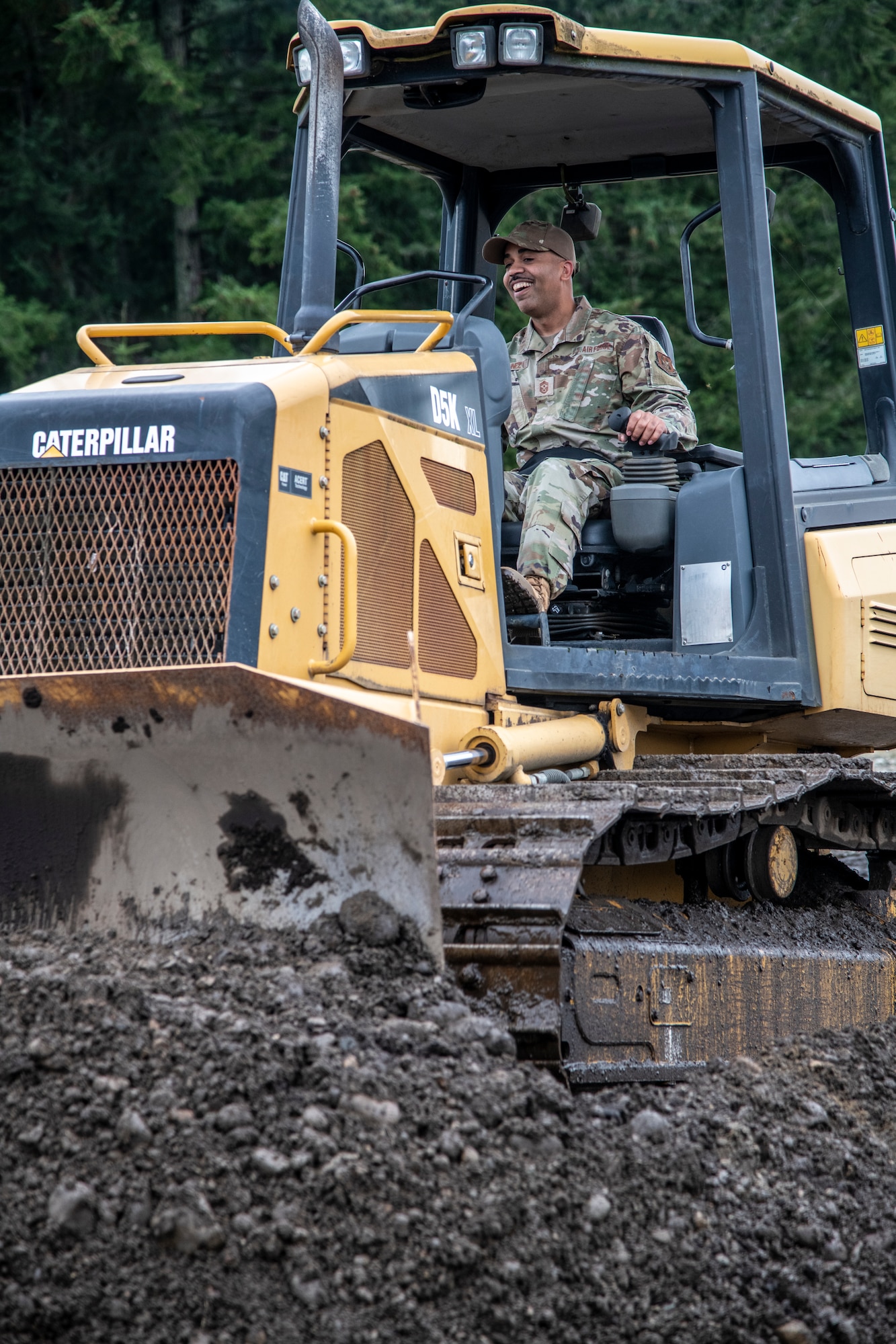 Airman drives a bulldozer.