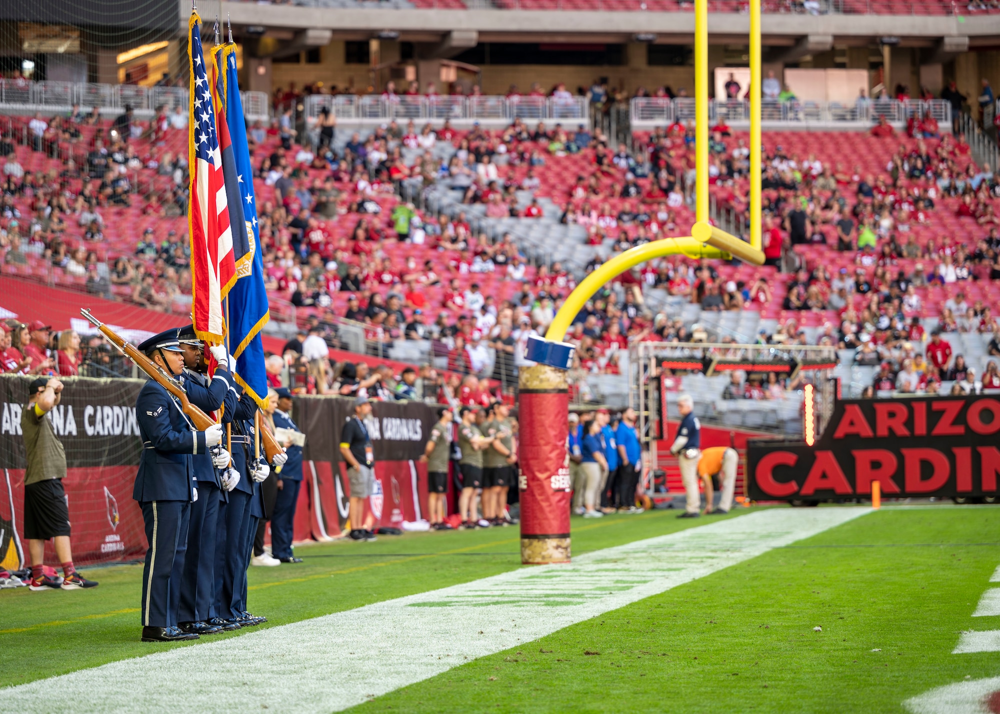 U.S. Air Force Honor Guardsmen assigned to the 56th Fighter Wing, Luke Air Force Base, stand at attention before the Arizona Cardinals Salute to Service event Nov. 6, 2022, at State Farm Stadium, Glendale, Arizona.