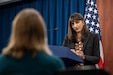 A woman speaks from a podium.