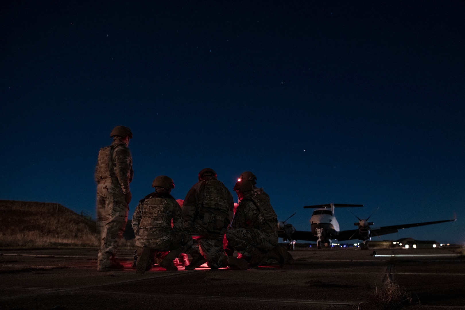 Members of the 137th Mission Sustainment Team look over a map as they conduct a site survey during ATREUS 22-4 at Andøya Space Defense Range, Norway, Nov. 8, 2022. This was the first time the multi-capable Airmen conducted their mission in a setting realistic to the austere environments they will encounter while supporting global SOF operations. (U.S. Air National Guard photo by Tech. Sgt. Brigette Waltermire)