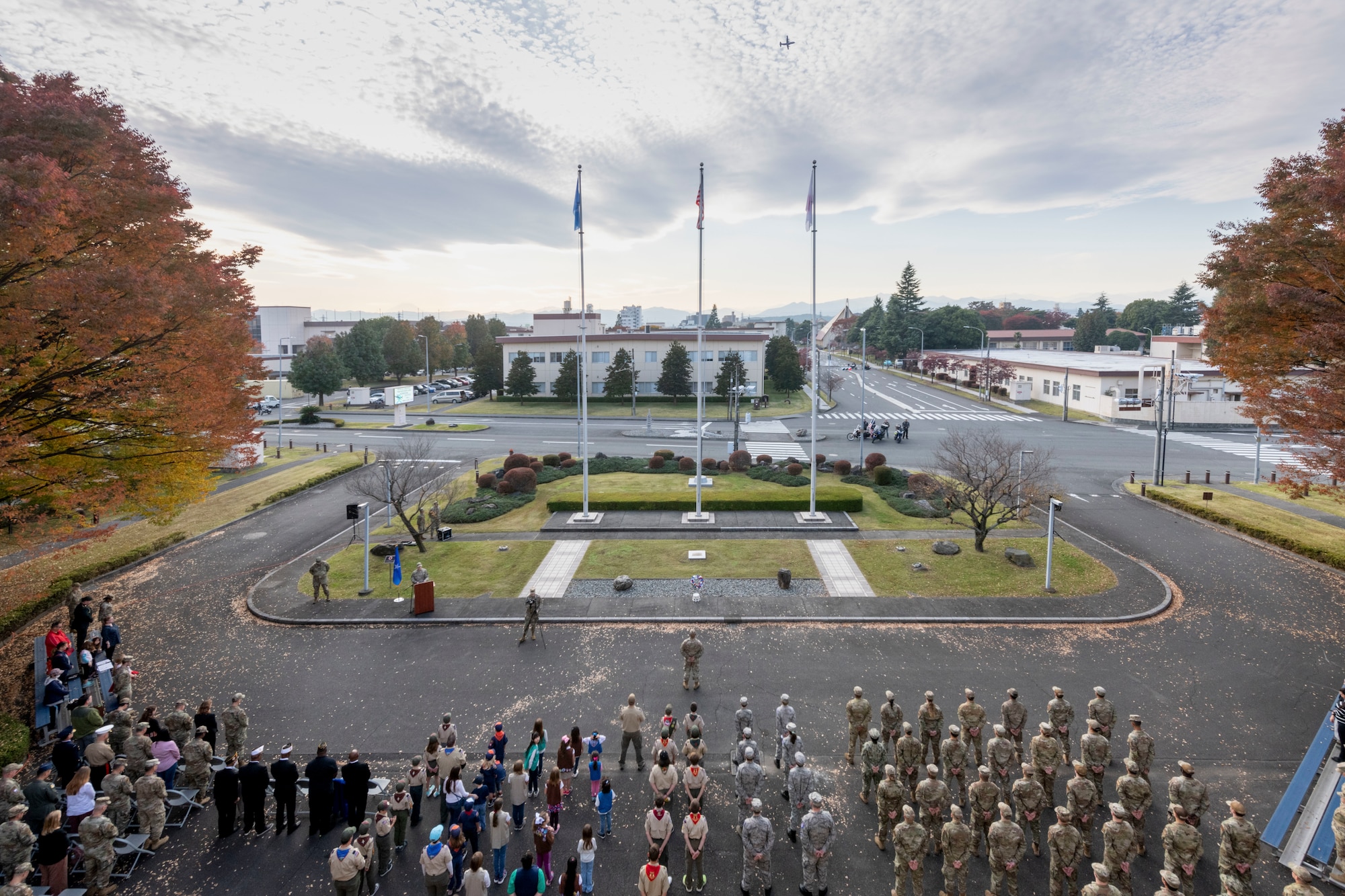 Service members and civilians participate in a retreat ceremony as part of the 2022 Yokota Veterans Day Ceremony at Yokota Air Base, Japan, Nov. 10, 2022. Members of Yokota conducted the ceremony to respect and recognize the contributions veterans and their families have made toward the cause of freedom and peace across the globe. (U.S. Air Force photo by Machiko Arita)