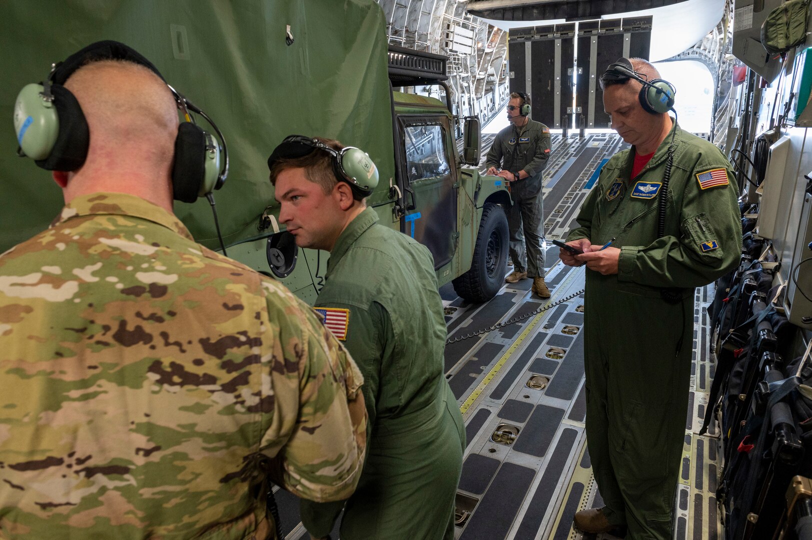 U.S. Air Force Senior Master Sgt. Daniel Ratcliffe, 167th Airlift Squadron loadmaster, right, evaluates loadmasters on their vehicle loading efforts during the 167th Operations Group rodeo event, at Shepherd Field, Martinsburg, West Virginia, Nov. 5, 2022. The rodeo was held to evaluate aircrew skills as part of a fun, friendly competition within the operations group.