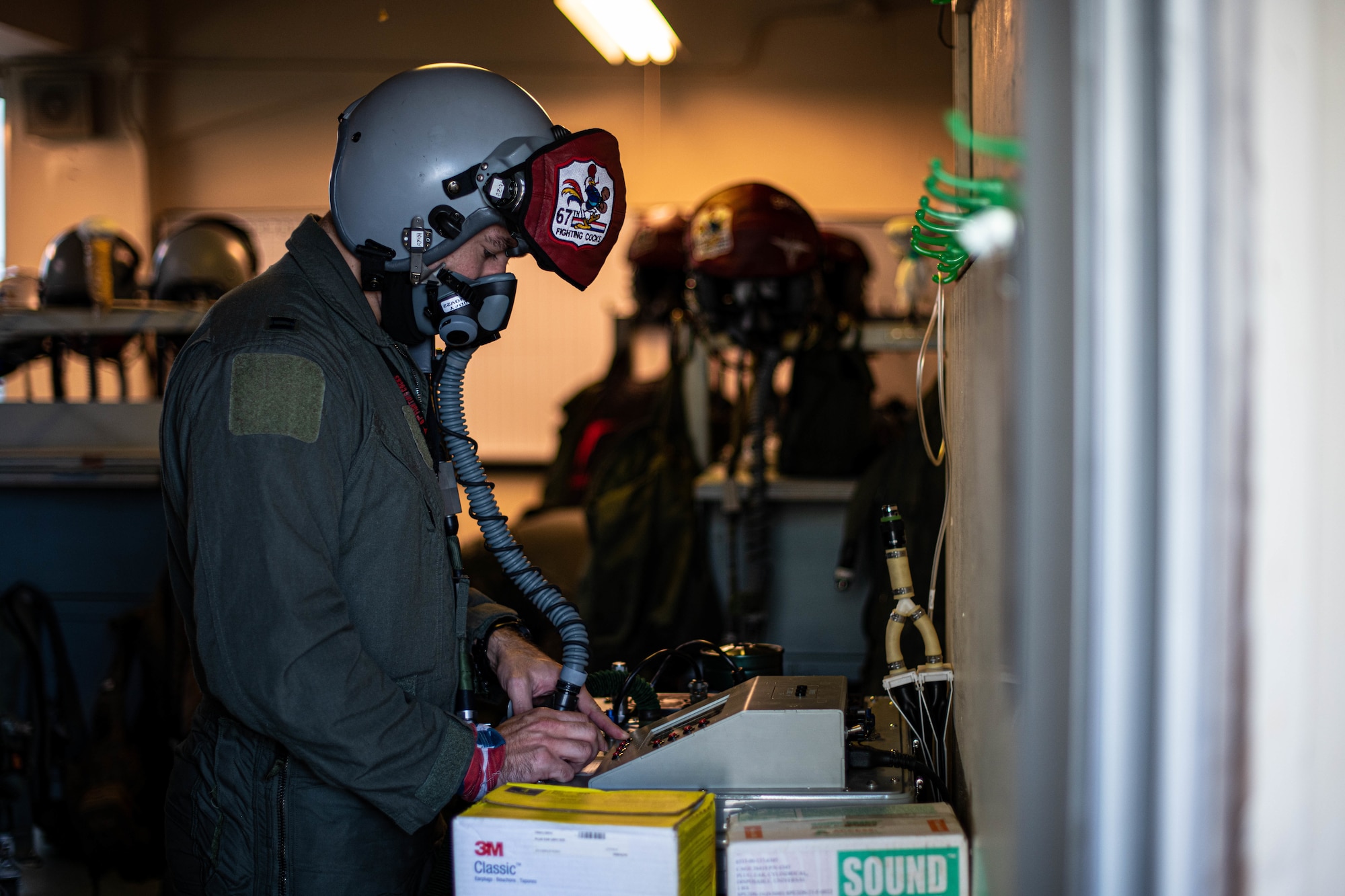 Pilot tests their oxygen mask.