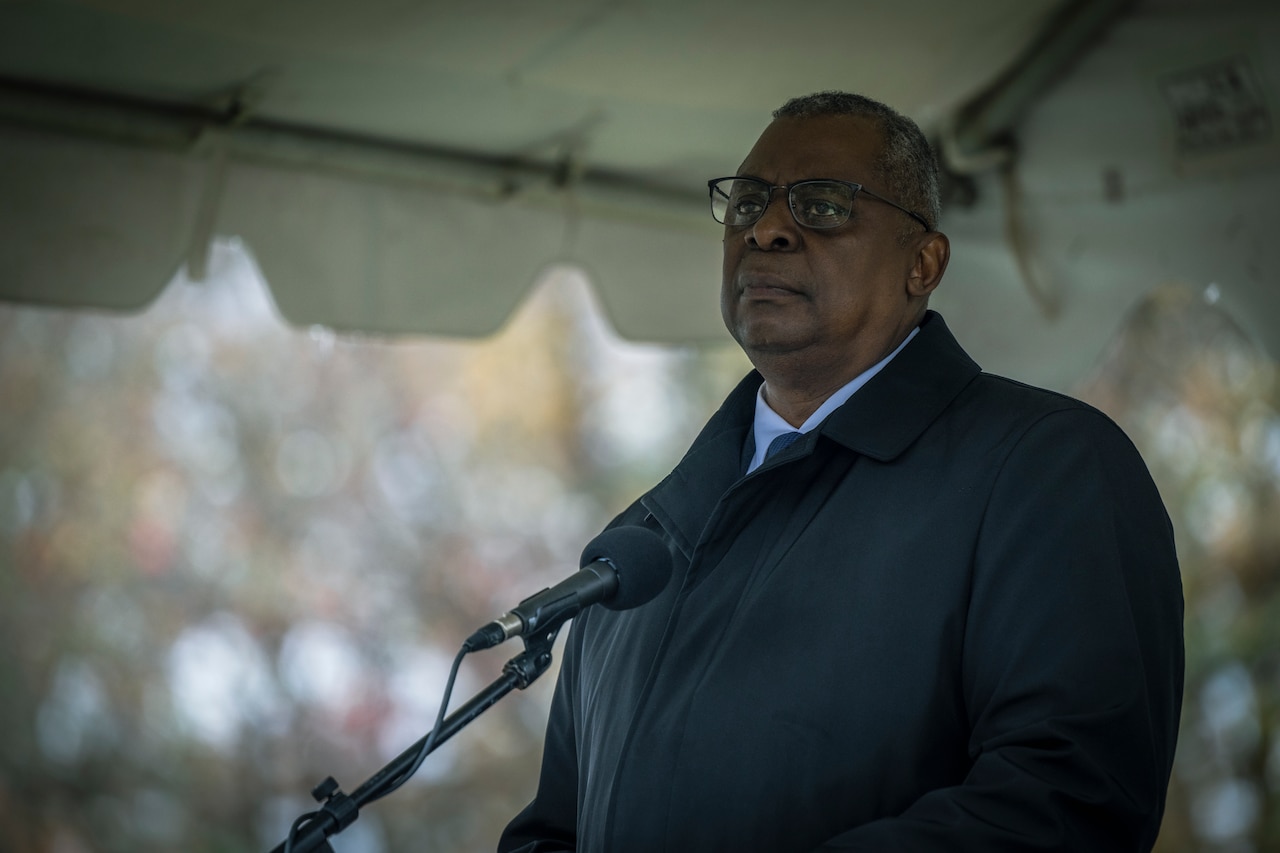 A man stands behind a lectern.