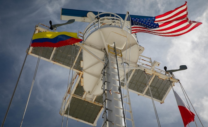 The U.S. and the Colombian flags fly on the yard arm of the hospital ship USNS Comfort (T-AH 20), as Comfort arrives in Cartagena, Colombia, Nov. 11, 2022.