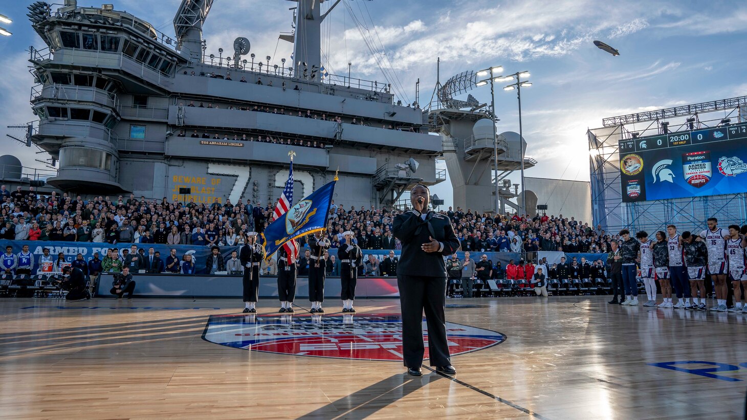 Aviation Boatswain's Mate (Equipment) 3rd Class Charitee Swift-Day sings the national anthem during the 2022 ESPN Armed Forces Classic-Carrier Edition aboard USS Abraham Lincoln (CVN 72) at Naval Air Station North Island, Calif.