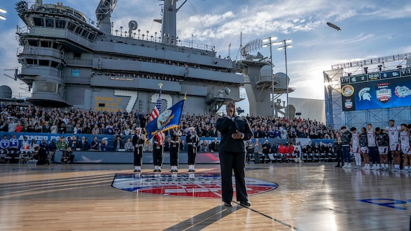 Aviation Boatswain's Mate (Equipment) 3rd Class Charitee Swift-Day sings the national anthem during the 2022 ESPN Armed Forces Classic-Carrier Edition aboard USS Abraham Lincoln (CVN 72) at Naval Air Station North Island, Calif.