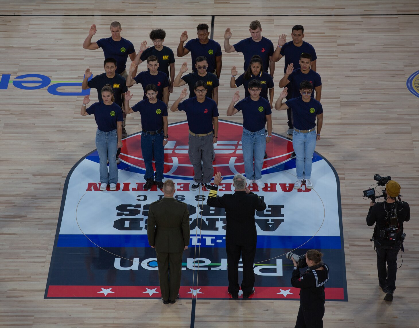 Vice Adm. Whitesell delivers the oath of enlistment during the 2022 ESPN Armed Forces Classic - Carrier Edition, aboard USS Abraham Lincoln (CVN 72) at Naval Air Station North Island.