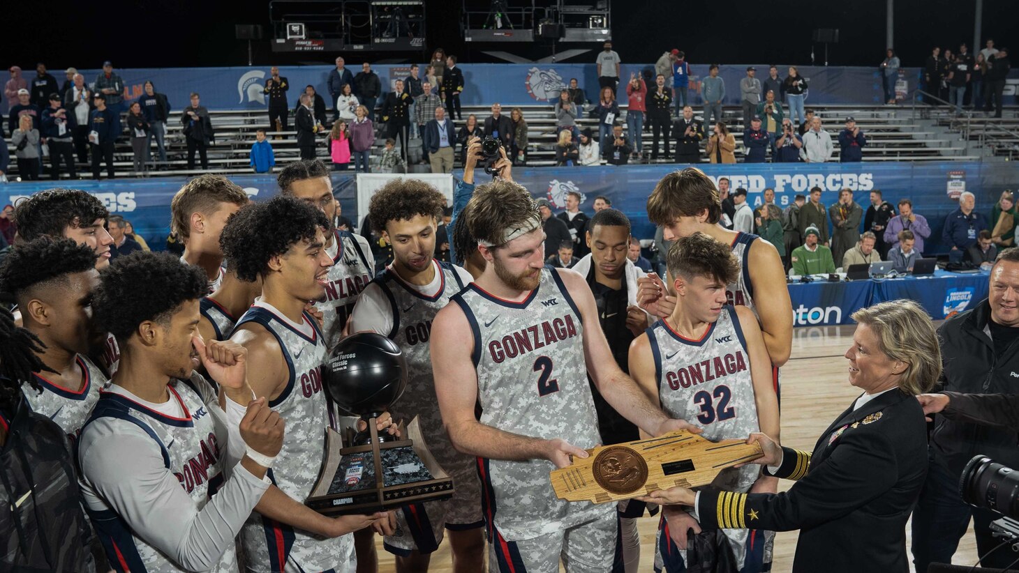 Gonzaga University forward Drew Timme, (2), receives the MVP plaque from Capt. Amy N. Bauernschmidt after the 2022 ESPN Armed Forces Classic-Carrier Edition aboard USS Abraham Lincoln (CVN 72) at Naval Air Station North Island.
