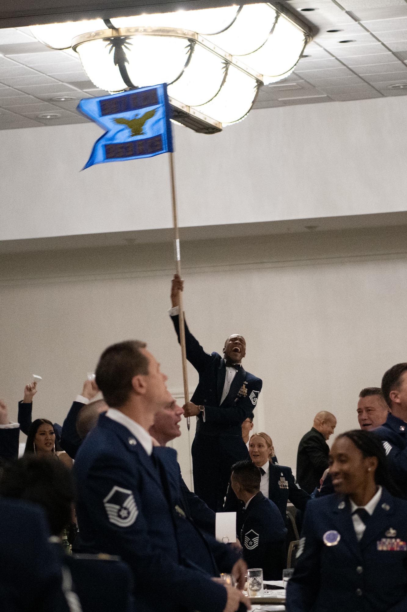 An Airmen holds up his squadron's guidon during a training event