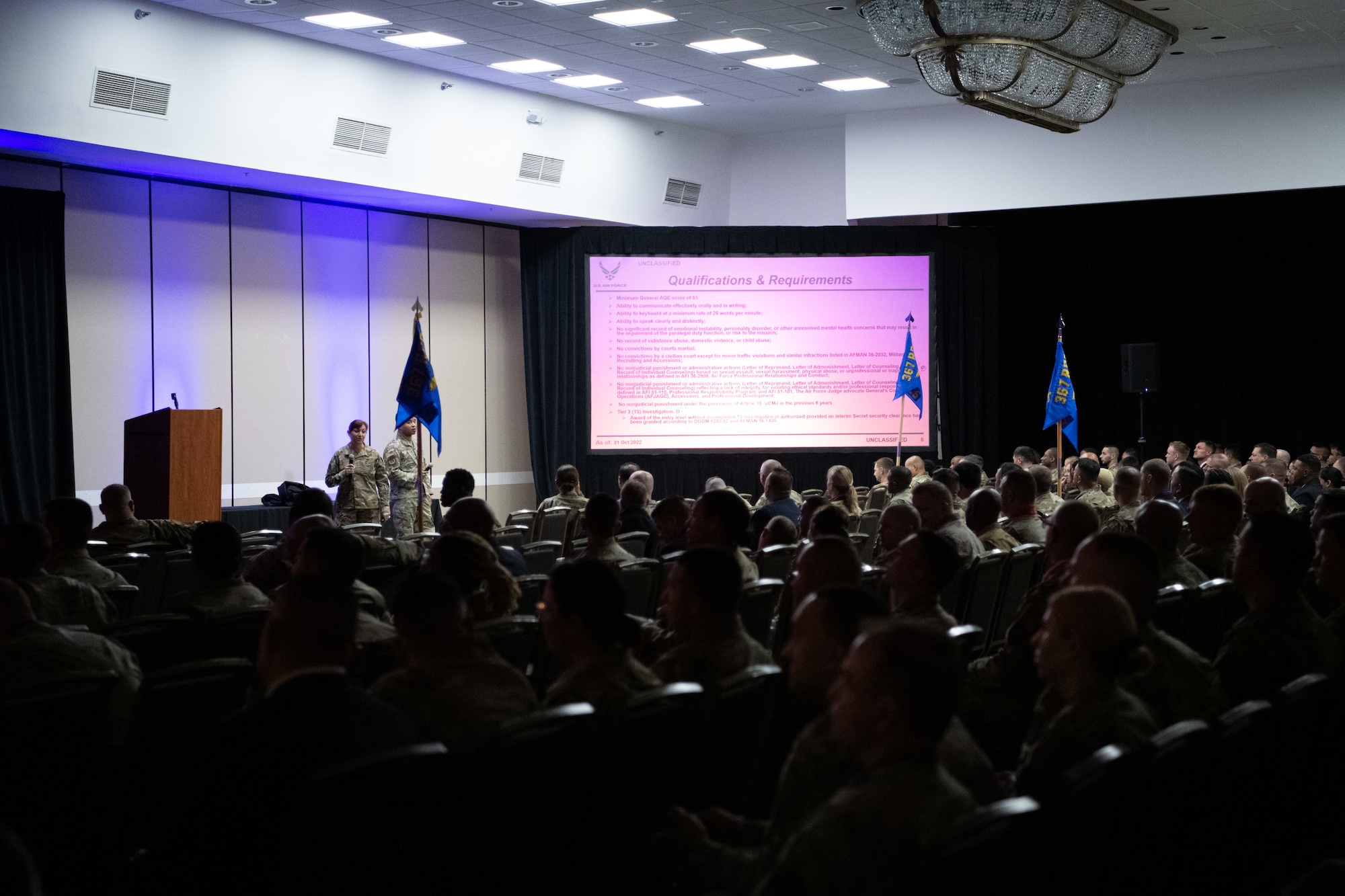 Air Force Reserve recruiters sit in a ballroom for training