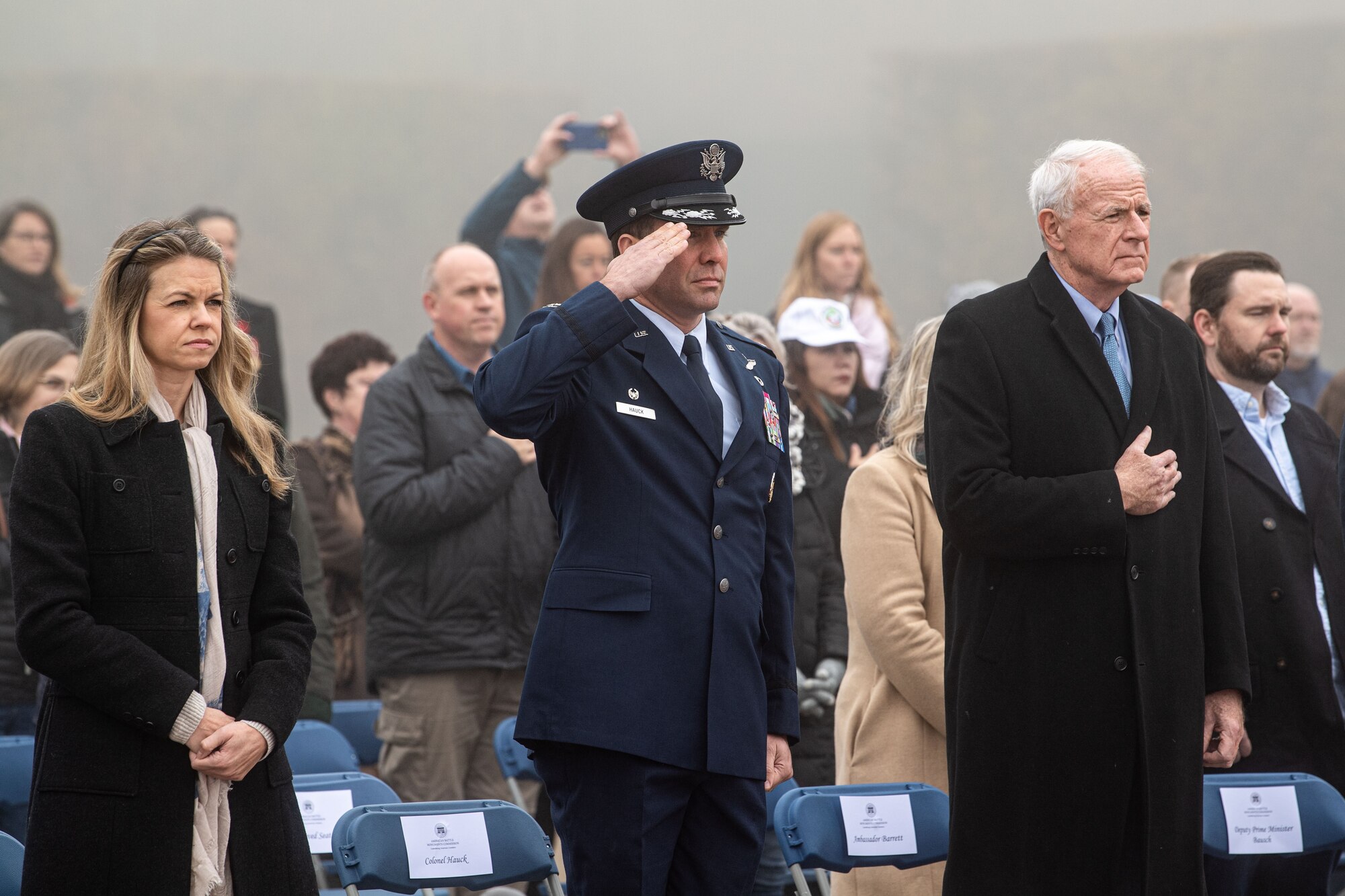 Col. Leslie Hauck, 52nd Fighter Wing commander, renders a salute during the U.S. National Anthem