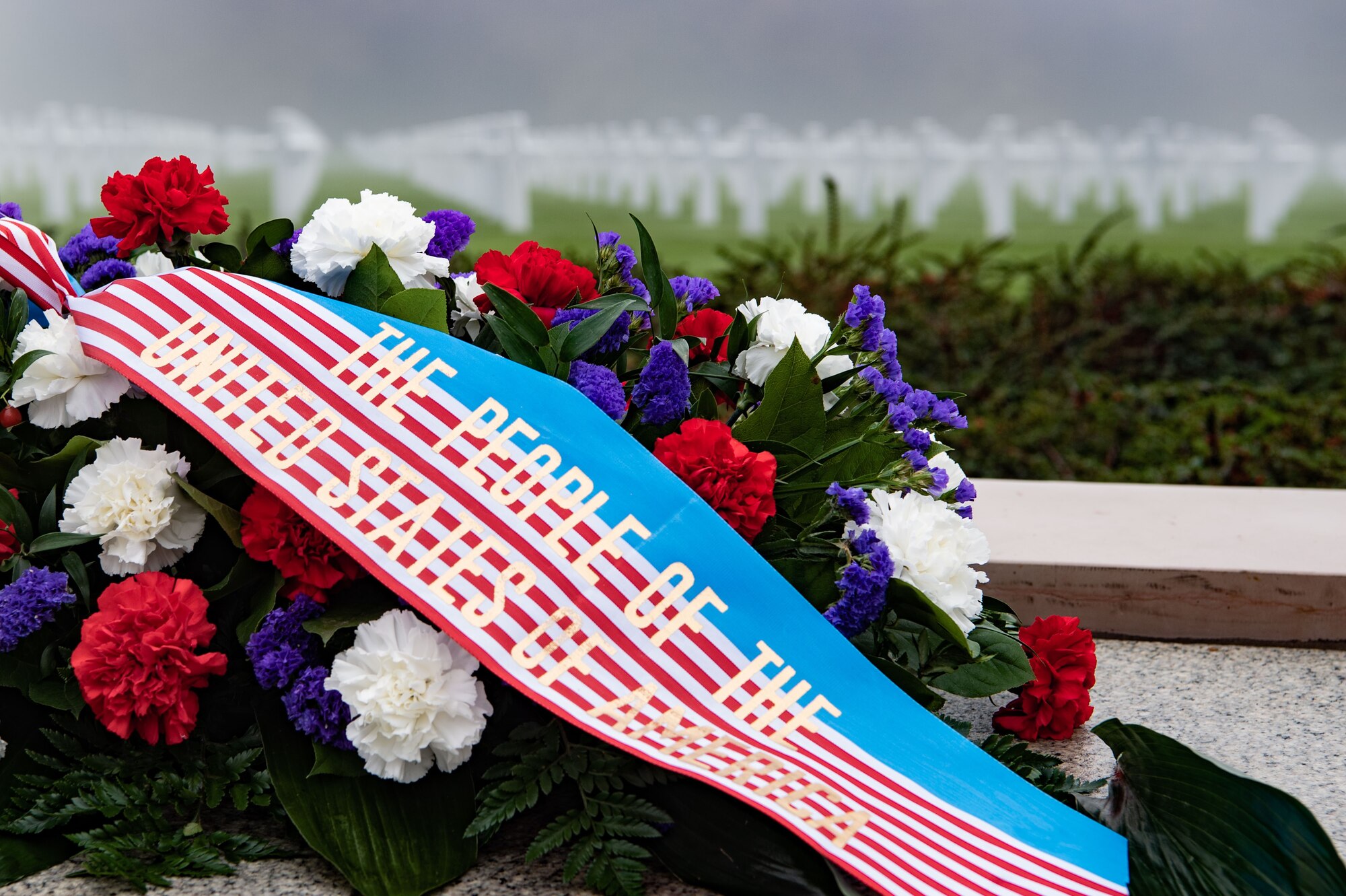 a wreath sits in front of the Luxembourg American Military Cemetery and Memorial
