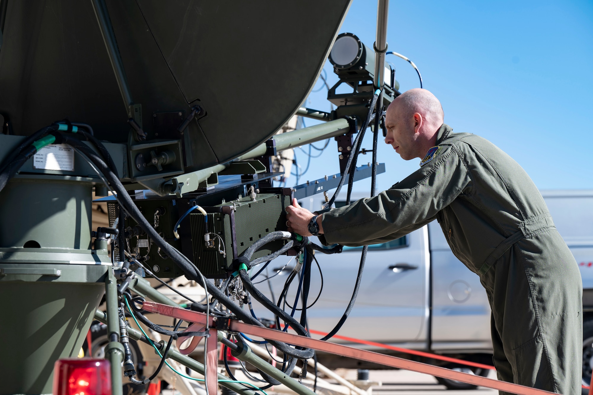U.S. Air Force Lt. Col. Mike Johnson, 26th Space Aggressor Squadron space control operator, performs a feed swap on an antenna