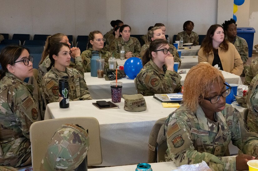 Women listen to Col. Elizabeth Hanson 305th Wing Commander as she discusses “unconscious bias” and how it affects each of us during a women’s breakfast discussion.