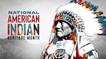 The 2022 Department of Defense NAIHM poster is focused on U.S. Army Technician 5th Grade Joseph Medicine Crow, the last Crow War Chief. Crow is artistically represented on the poster in traditional Crow war bonnet and clothing made of leather, animal fur, beads, bones, and eagle feathers.