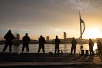 Sailors man the rails aboard the Arleigh Burke-class guided missile destroyer USS Thomas Hudner (DDG 116) as part of the Gerald R. Ford Carrier Strike Group, as the ship ports in Portsmouth, England on Nov. 14, 2022. The first-in-class aircraft carrier USS Gerald R. Ford (CVN 78) is on its inaugural deployment conducting training and operations alongside NATO Allies and partners to enhance integration for future operations and demonstrate the U.S. Navy’s commitment to a peaceful, stable and conflict-free Atlantic region. (U.S. Navy photo by Mass Communication Specialist 3rd Class Chelsea Palmer)