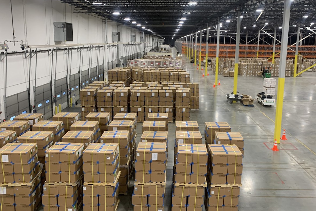 Multiple pallets of boxes sit in a warehouse.