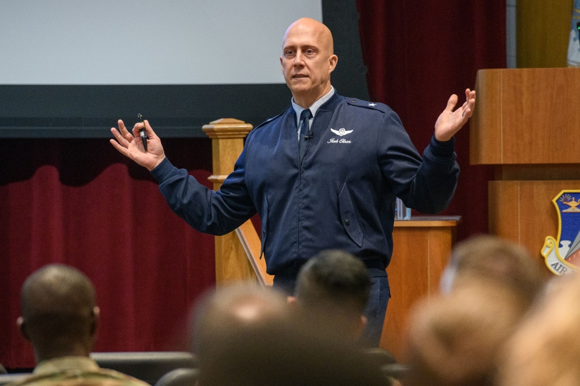 Brig. Gen. Joshua Olson presenting in front of a crowd