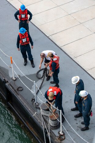 Sailors assigned to the-first-in-class aircraft carrier USS Gerald R. Ford’s (CVN 78) deck department, prepare to dock with an approaching barge during a visit to Portsmouth, England, Nov. 14, 2022. The Gerald R. Ford Carrier Strike Group (GRFCSG) is deployed in the Atlantic Ocean, conducting training and operations alongside NATO Allies and partners to enhance integration for future operations and demonstrate the U.S. Navy’s commitment to a peaceful, stable and conflict-free Atlantic region. (U.S. Navy photo by Mass Communication Specialist 3rd Class Grant Gorzocoski)