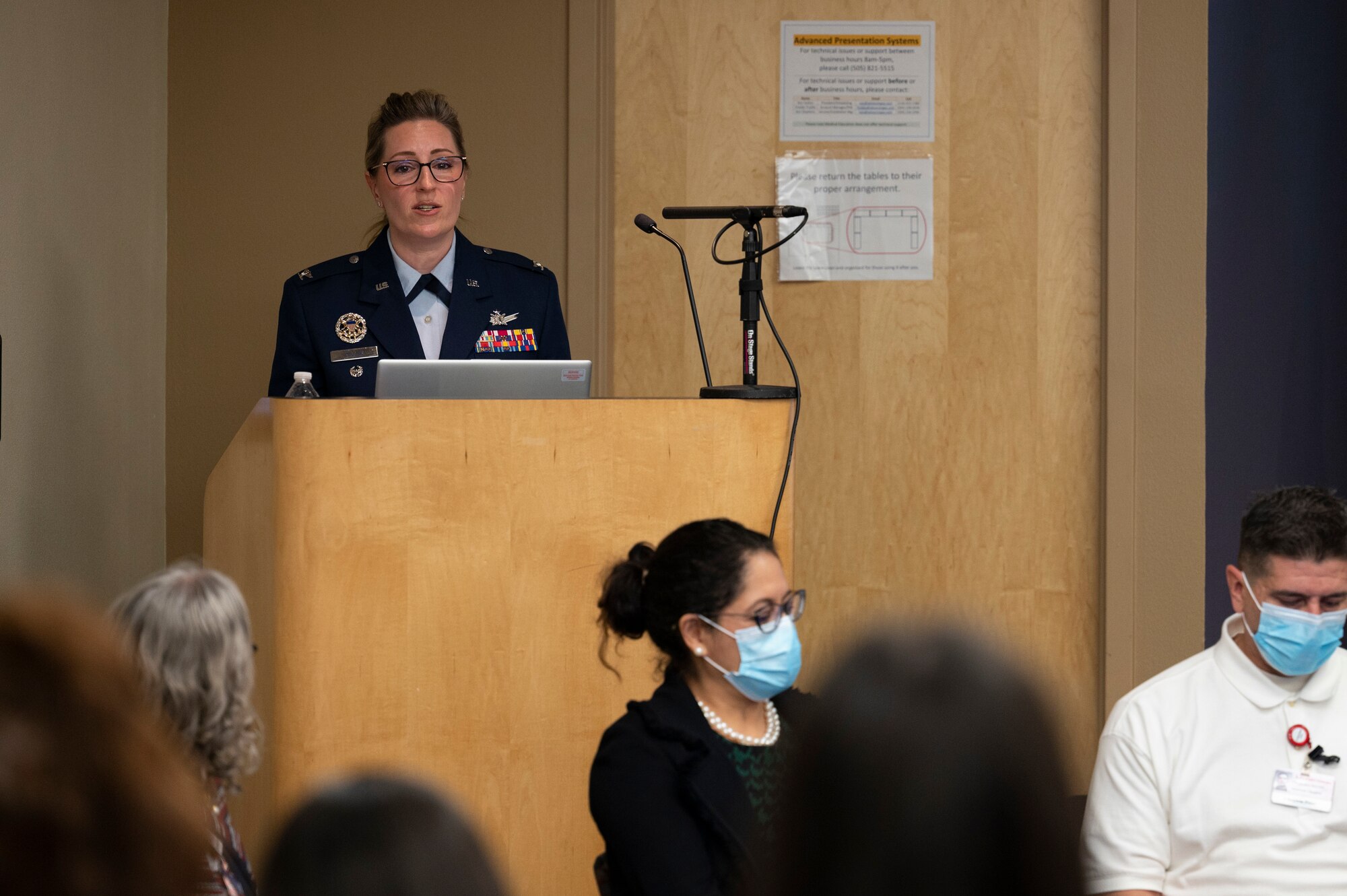 A woman speaks at a podium.