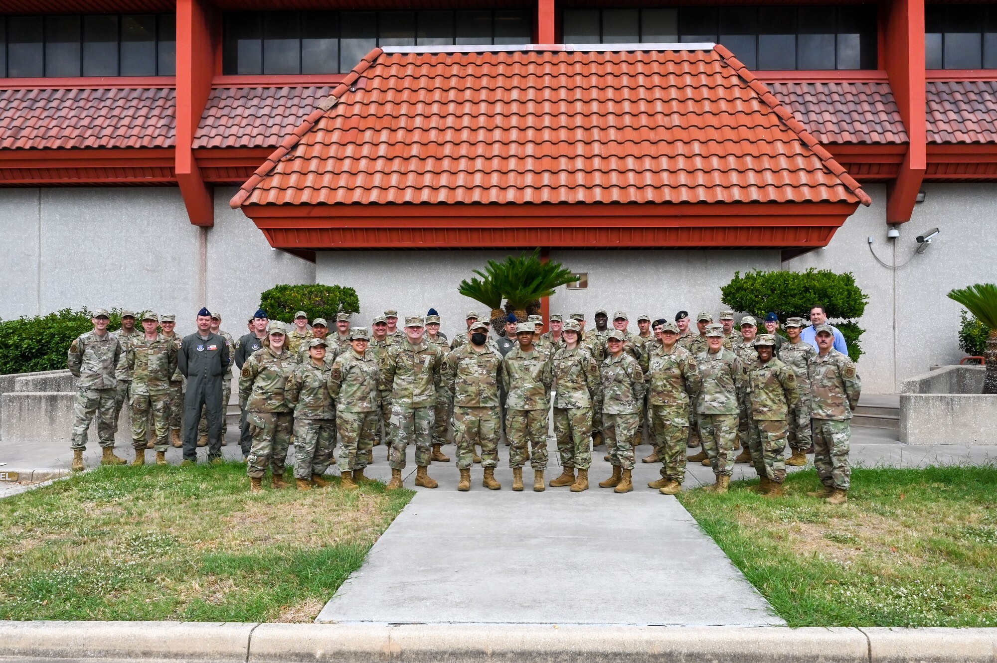 Participants of the Triad Summit stand for a photograph at Joint Base San Antonio-Lackland, Texas, Nov. 3, 2022. The two-day event covered a variety of topics with activities focused on understanding each component of the triad and personal development. The Triad Summit was the first of its kind tested at the 433rd AW and served as professional development for those who collaborate in leadership positions to ensure the unit meets mission requirements. (U.S. Air Force photo by Staff Sgt. Adriana Barrientos)