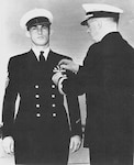 Ray Evans receiving his Navy Cross Medal for action seen at Point Cruz. Evans had already received a battlefield advancement to chief petty officer and later received an officer’s commission. (Coast Guard Collection)