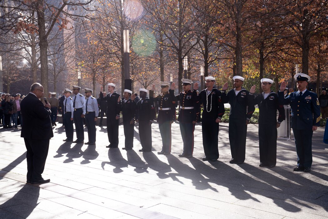 U.S. Secretary of the Navy Carlos Del Toro conducts a multi-military branch re-enlistment at the 9/11 Memorial reflection pools in New York, Nov. 10, 2022.