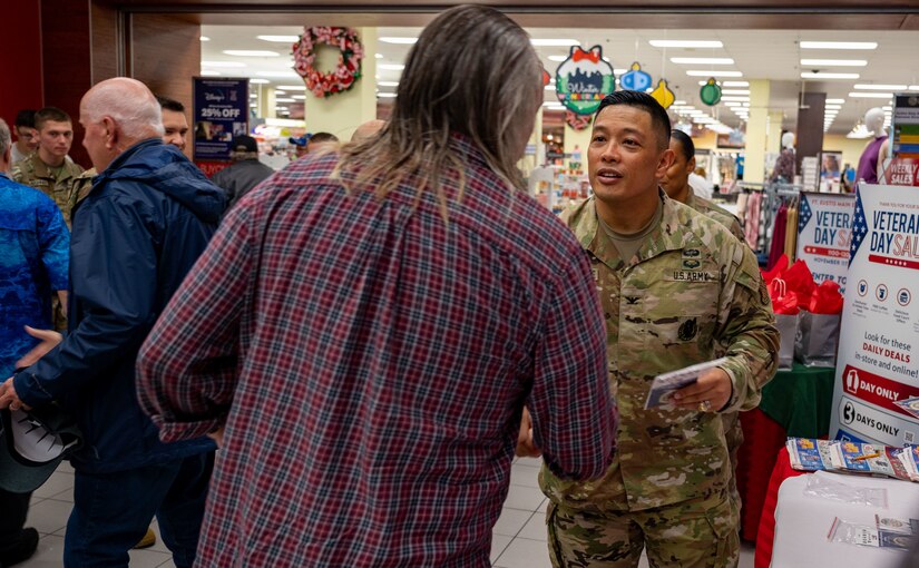 U.S. Army Col. Frankie Cochiaosue, 733d Mission Support Group commander, coins a veteran