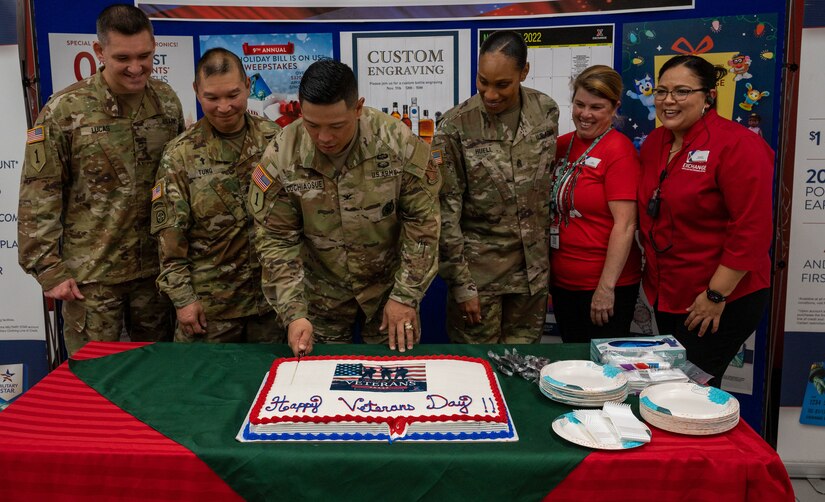 U.S. Army Col. Frankie Cochiaosue, 733d Mission Support Group commander, cuts the ceremonial cake