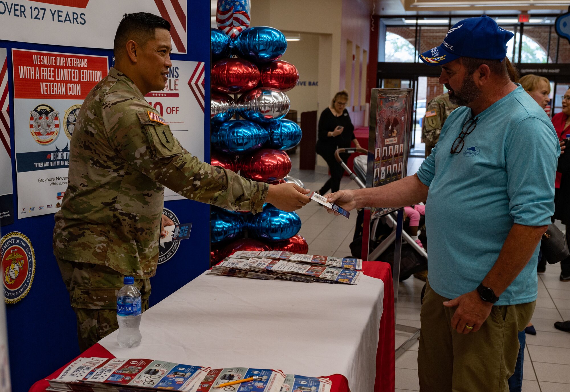 U.S. Army Col. Frankie Cochiaosue, 733d Mission Support Group commander, coins a veteran