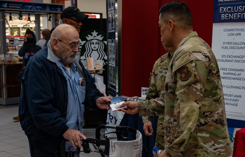 U.S. Army Col. Frankie Cochiaosue, 733d Mission Support Group commander, coins a veteran