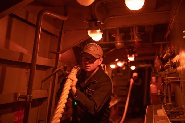 Electronics Technician 2nd Class Garrett Reeseman carries a mooring line aboard the Arleigh Burke-class guided missile destroyer USS Thomas Hudner (DDG 116) as part of the Gerald R. Ford Carrier Strike Group, on Nov. 14, 2022. The first-in-class aircraft carrier USS Gerald R. Ford (CVN 78) is on its inaugural deployment conducting training and operations alongside NATO Allies and partners to enhance integration for future operations and demonstrate the U.S. Navy’s commitment to a peaceful, stable and conflict-free Atlantic region. (U.S. Navy photo by Mass Communication Specialist 3rd Class Chelsea Palmer)