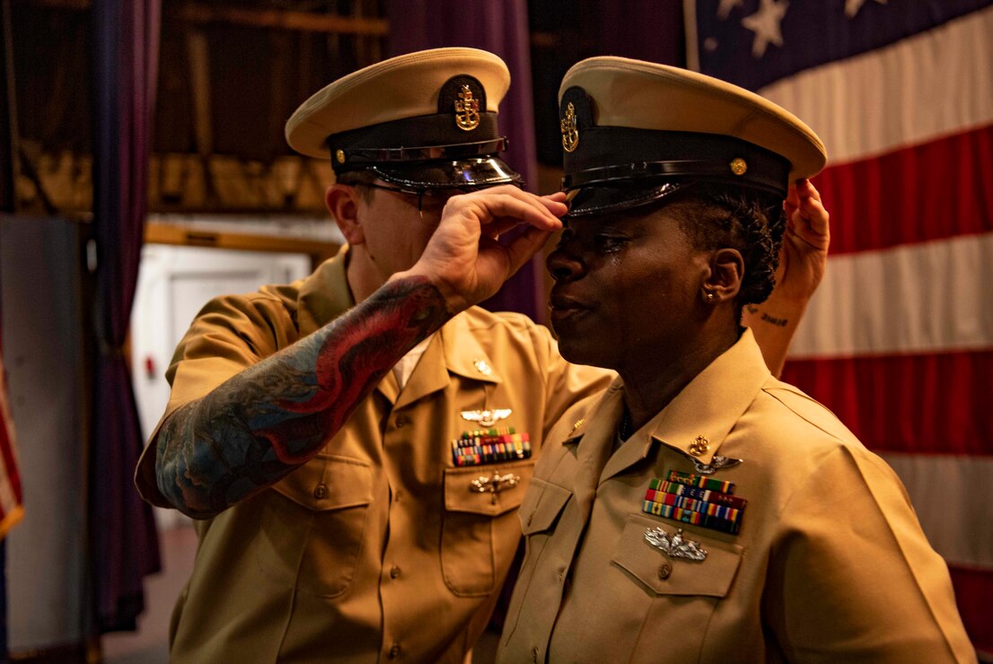 Chief Aviation Ordnanceman Cametria Tobias receives her combination cover during a chief petty officer pinning ceremony at Naval Base Kitsap-Bremerton, Washington Oct. 21, 2022. The rank of chief petty officer was officially established April 1, 1893, and holding the title "Chief" means a Sailor has achieved senior non-commissioned officer status. (U.S. Navy photo by Mass Communication Specialist 2nd Class Gwendelyn L. Ohrazda)