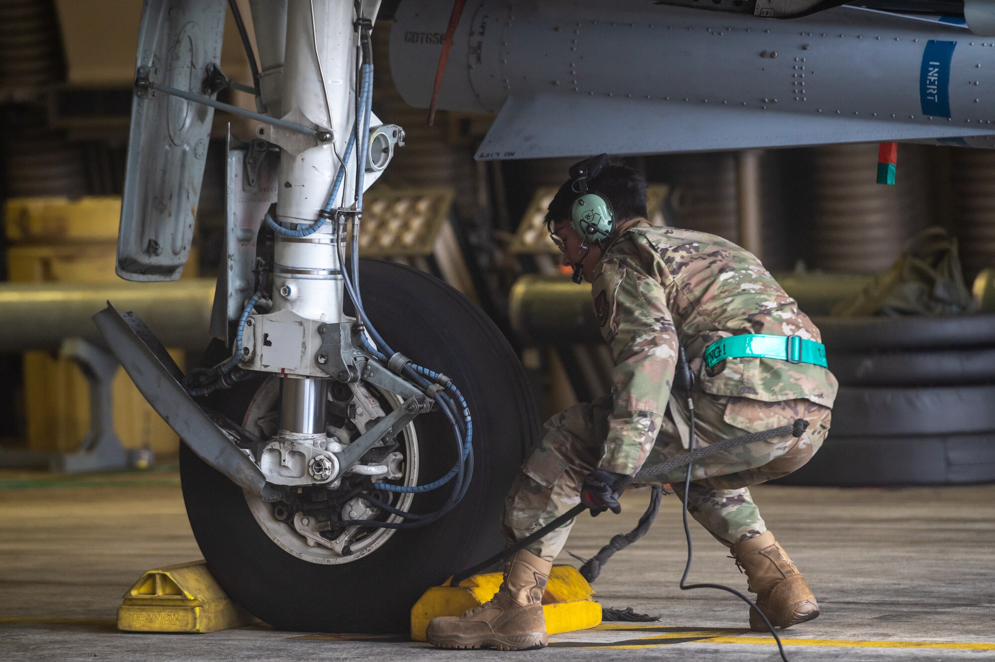 U.S. Air Force Staff Sgt. John-Michael Salenga, 25th Fighter Generation Squadron crew chief, pulls chalks for an A-10C Thunderbolt II to taxi for takeoff as part of an agile combat employment (ACE) training sortie