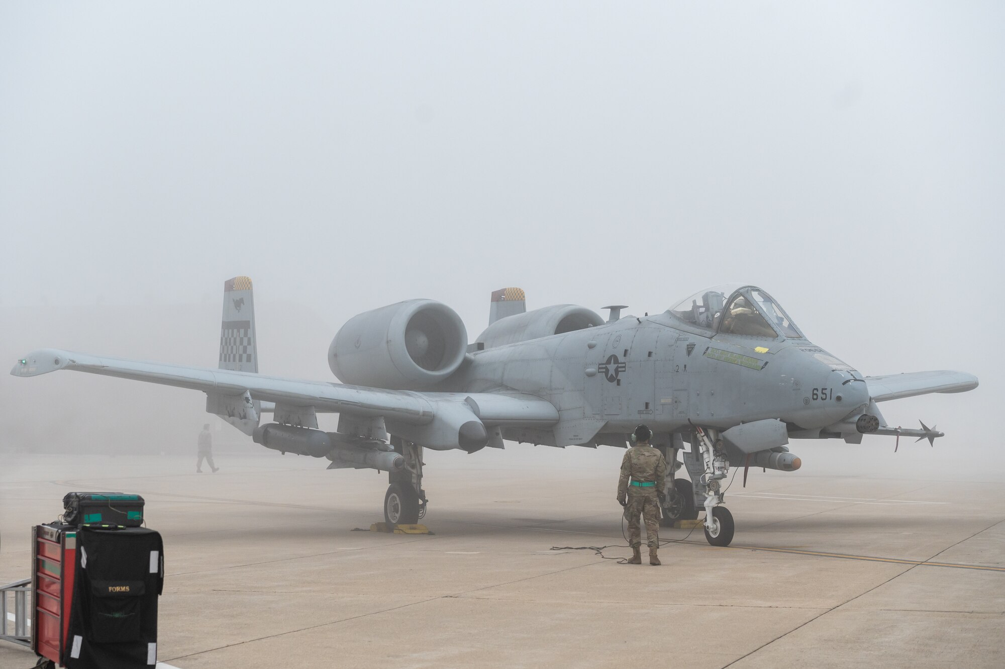 U.S. Air Force Staff Sgt. John-Michael Salenga, 25th Fighter Generation Squadron crew chief, communicates with USAF Capt. Jacob Bouck, 25th Fighter Squadron pilot, during preflight checks for an A-10C Thunderbolt II