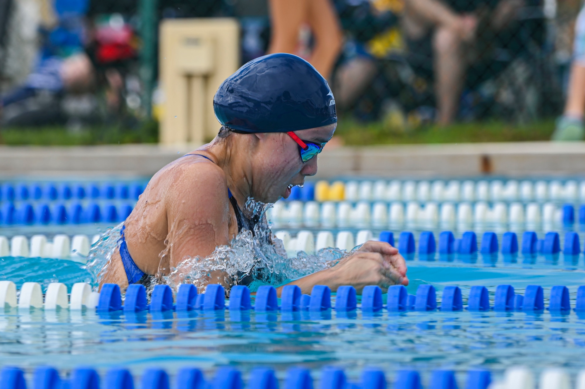 A swimmer swims breaststroke.