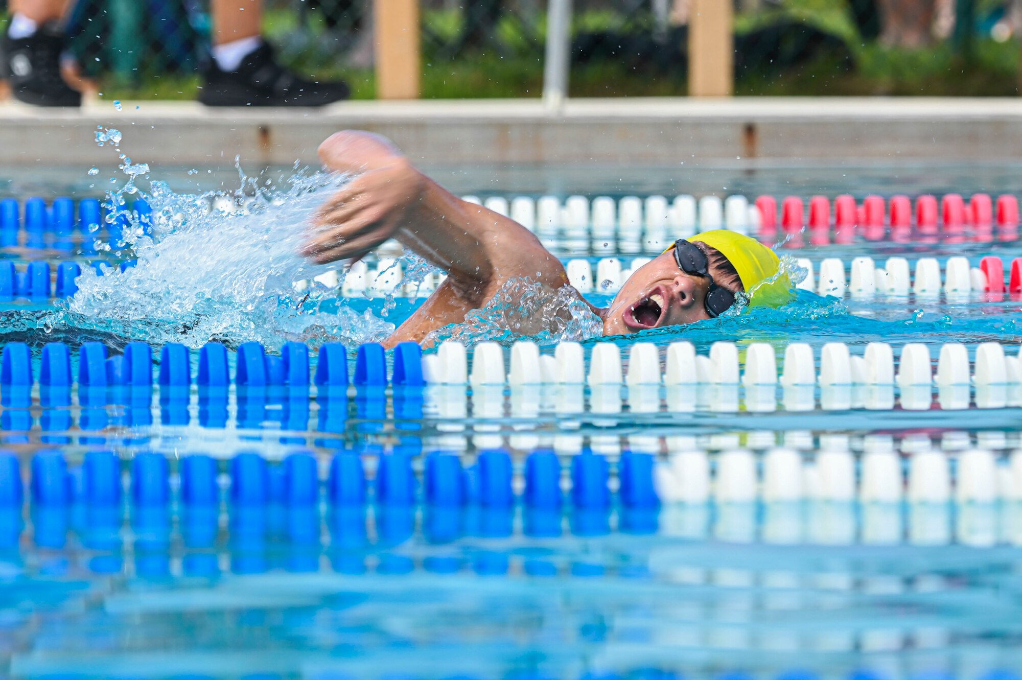 A swimmer swims freestyle.