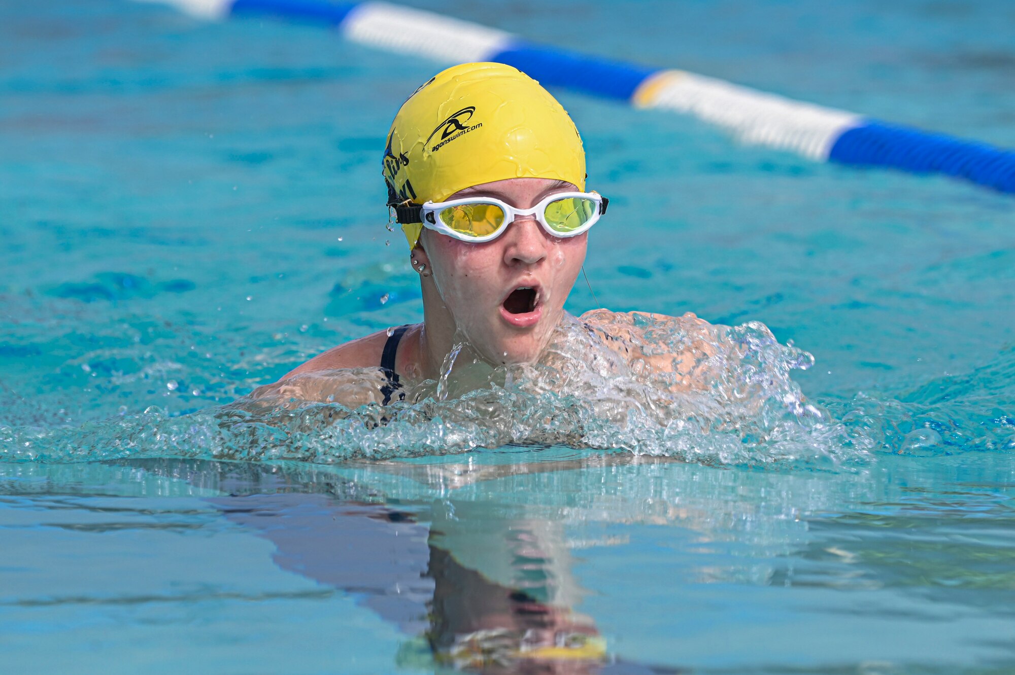 A swimmer swims breastroke